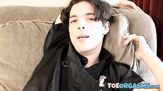 Skinny twink massages his feet and strokes massive dick